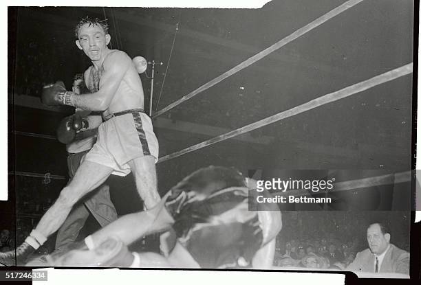 Carmen Basilio stands over Tony DeMarco after flooring him with a barrage of lefts and rights in the 12th round of their welterweight championship...