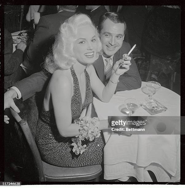 Mamie Van Doren and bandleader husband, Ray Anthony are shown having cocktails at Macambo's in Hollywood.
