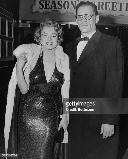 Beauteous film star, Marilyn Monroe, and her author husband, Arthur Miller, attend the premiere of Alia Kazan's Baby Doll at New York's Victoria...