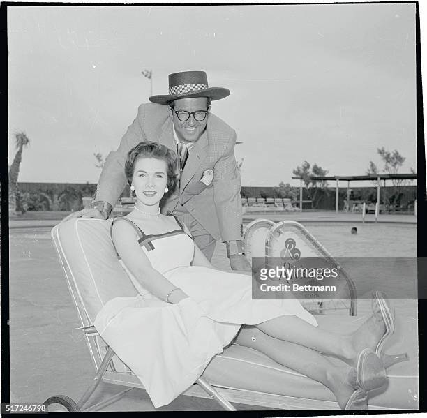 Comedian Phil Silvers of Sgt. Bilko television fame, and New York model Evelyn Patrick relax at the Hotel Riviera here May 25th, as rumors continue...