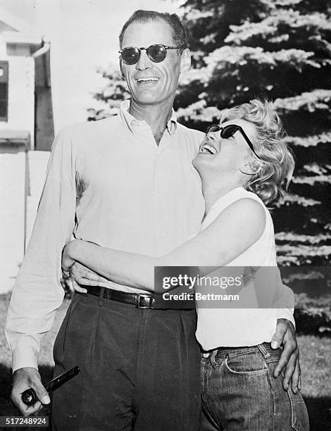 Marilyn Monroe hugs Arthur Miller at the playwright's 20-acre summer home here, June 25th. The wedding date is still indefinite.