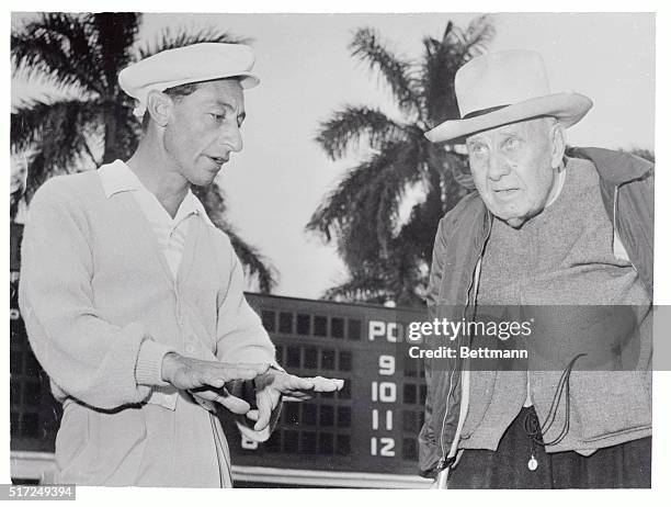 Jockey Eddie Arcaro discusses the action of Wheatley Stable's "Bold Ruler" with trainer "Sunny Jim" Fitzsimmons after giving the Florida Derby...