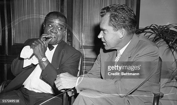 Goodwill Ambassadors. Washington: Using his favorite mouthpiece, Louis Armstrong, famed musician, demonstrates to Vice President Richard M. Nixon the...