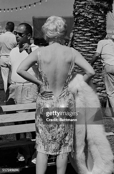 Wearing her heart on her hip instead of her sleeve, movie eyeful Marilyn Monroe casts a backward glance during a solitary stroll. Marilyn was on...