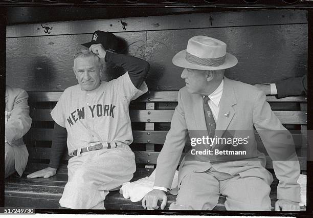 American league All-Star manager Casey Stengel and newly re-elected baseball commissioner Ford Frick chat in dugout as American League team readied...