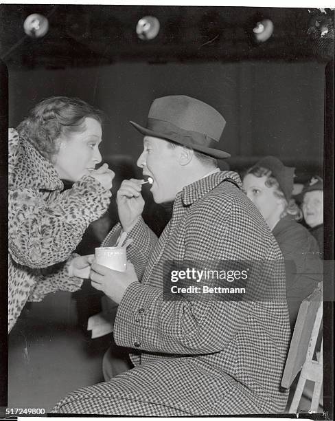 Eleanore Whitney and Jack Oakie, Paramount performers, share a container of ice cream on the set at the West Coast Studios.