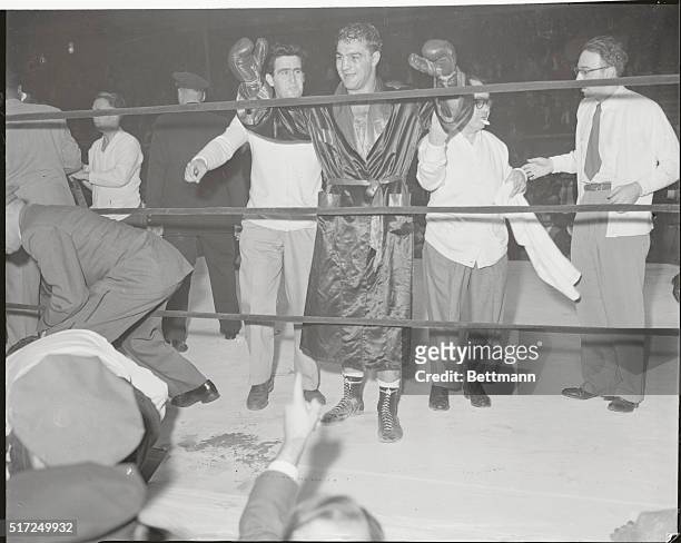 The Victor: Rocky Marciano makes the sign of victory in the ring at Madison Square Garden tonight after winning a TKO over Joe Louis in the eighth...