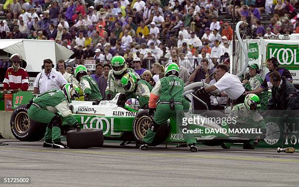Scottish driver Dario Franchitti sits in his final pit stop of the race as his crew works on his car at the Marconi Grand Prix of Cleveland 01 July...