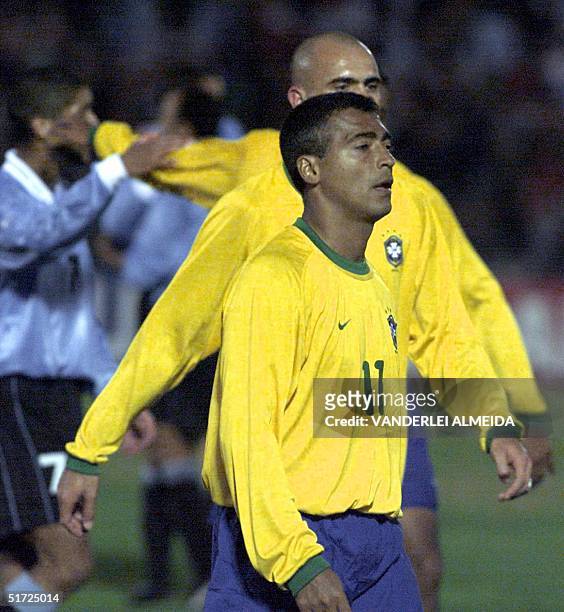Brazilian players Romario and Cris retire from the field following defeat by Uruguay in their 2002 FIFA World Cup Korea-Japan qualifying match 01...