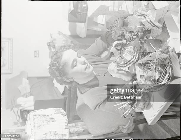 Dark Rapture. Lumia Lady: Here is Miss Iris Halsey at work on some of her dolls. She is touching them up with her luminous material so that they will...