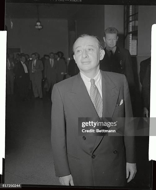 Showman Billy Rose appears a bit glum as he prepares to leave the Supreme Court Building, on September 10th, after withdrawing divorce charges...