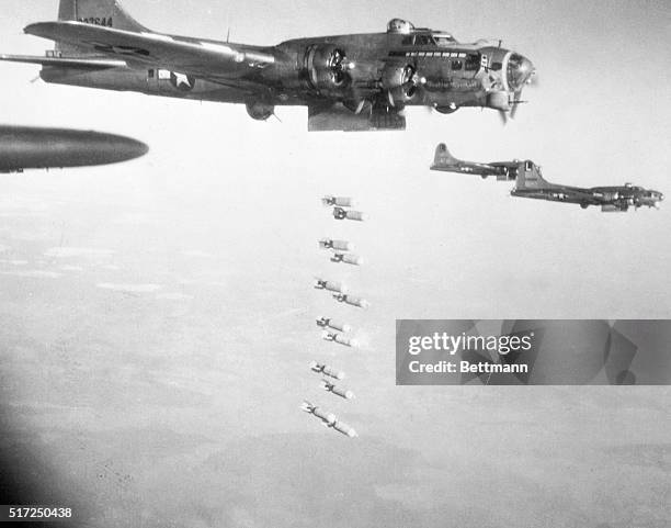 Germany: B-17, Flying Fortresses of the U. S. Eighth Air Force drop their holiday greetings from open bomb-bay doors, high over Germany on December...