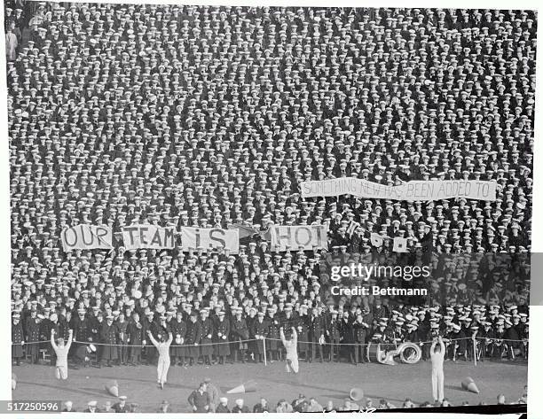 Huge banner with one word missing appears during a cheer by Midshipmen of the United States Naval Academy at municipal Stadium in Philadelphia. A red...