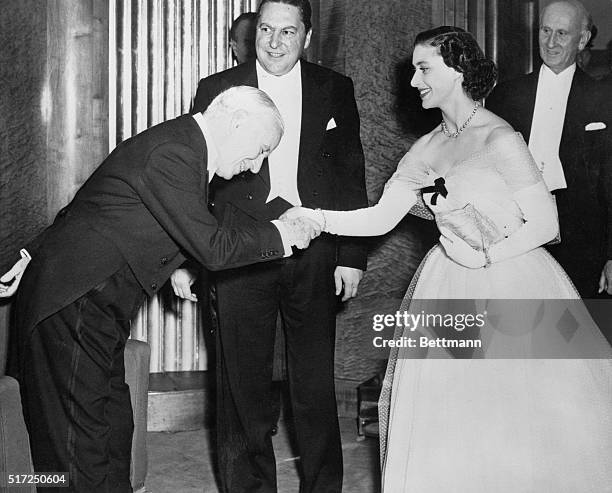 Chaplin bows to royalty. London: Princess Margaret, dressed in an off-the-shoulder white tulle gown, is greeted by Charlie Chaplin on her arrival at...