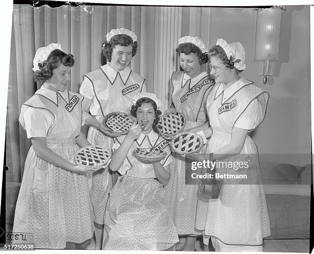 Winner of the 21st Annual National Cherry Pie Baking Contest, 16-yr-old Maxine Walker, of Huntsville, Alabama, has an approving audience as she...