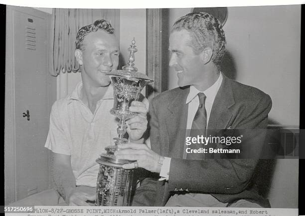 Arnold Palmer , a Cleveland salesman, and Robert Sweeny, Port Washington, N.Y. Millionaire, eye the trophy which one of them will win 8/28 in the...