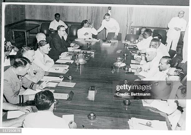 India's Prime Minister Jawaharlal Nehru, , enjoys a laugh with other members of the Indochina International Supervisory Commission, which was...