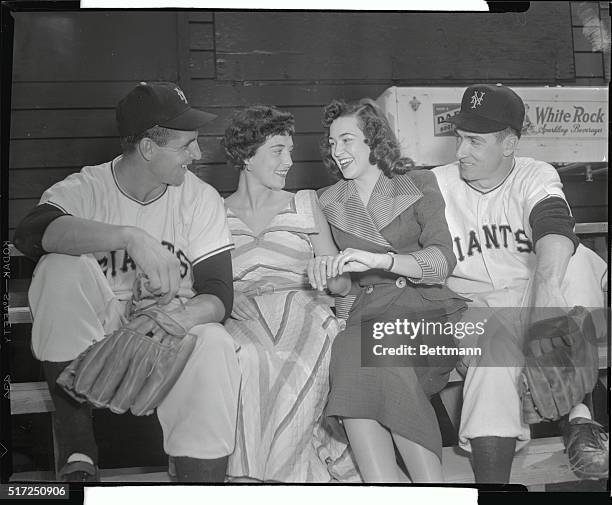 Giant ball players take time out from training to show their recent brides the training camp at Phoenix, Arizona. Enjoying the practice session are...