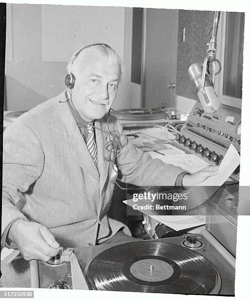 Noted orchestra leader Arthur Fiedler of the Boston "Pops" spins a record while doing a disc-jockey stint for radio station KEAR in San Francisco,...