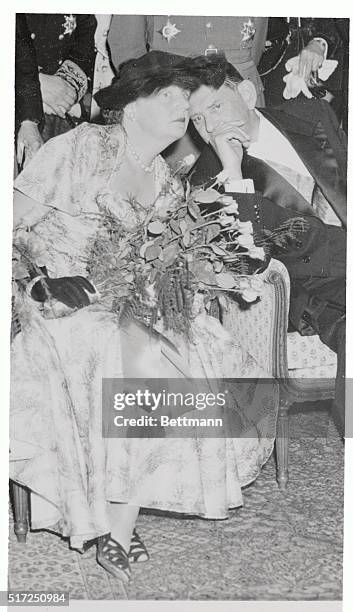 Queen Juliana of the Netherlands lends a curious royal ear to a whispered tid-bit from the lips of French President Rene Coty during a reception for...