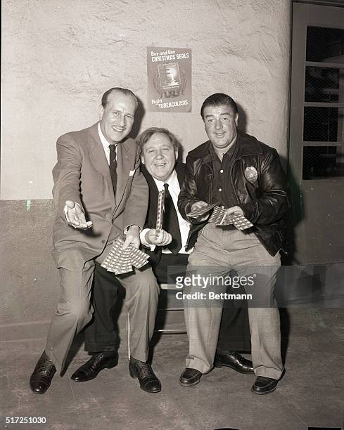 Hollywood, CA- Dramatic actor, Charles Laughton joins comic team, Bud Abbott and Lou Costello, in a symbolic offer of Christmas Seals to the general...