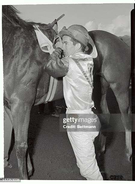 Jockey Willie Shoemaker, shown preparing for a race, is booting them home at Santa Anita Race Track these days. According to racing men, Shoemaker is...