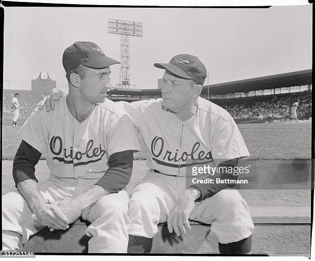 Orioles' manager Jimmy Dykes looks worried as he chats with veteran right fielder Cal Abrams at Boston where Baltimore lost to the Red Sox, 3-2....