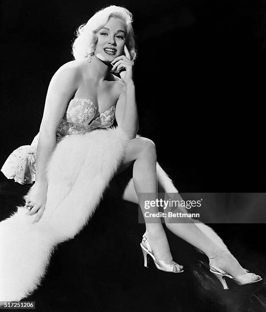 Lovely Blonde Actress Mamie Van Doren poses prettily and makes it look easy. However, Mamie Assures us that making this kind of picture is really...