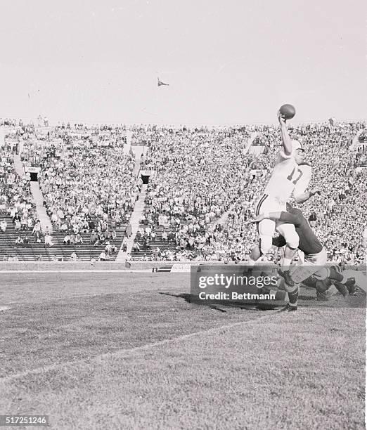 Minnesota quarterback Don Swanson's attempt to pass to Darrell Cochran is blocked by Michigan's Mike Rotunno in the third quarter of the game....