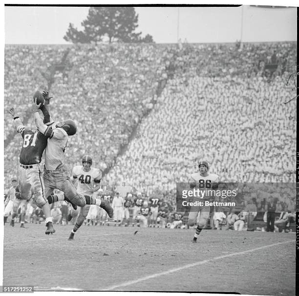 Stanford's Bob Gergen barely gets his hand on a ball thrown to him, as USC's Leon Clarke claws the air trying to intercept during the third quarter...