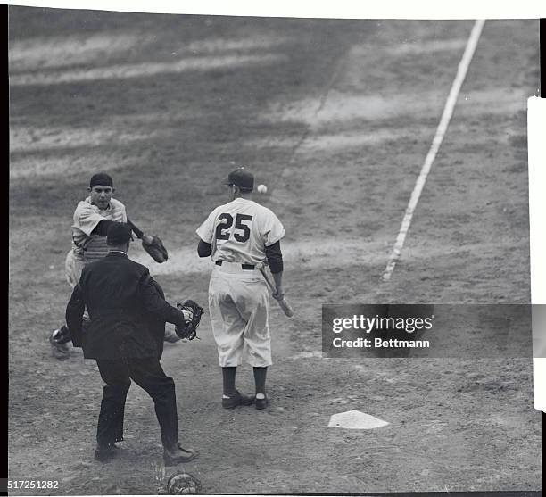 Catcher Yogi Berra of the New York Yankees says it with gestures as he fails to see eye-to-eye with umpire Rommel in the third game of the World...