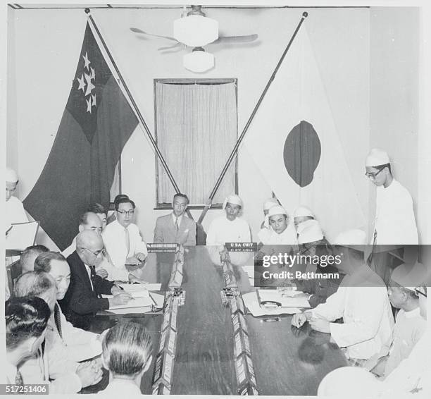 Representatives of Burma and Japan above sign a treaty of peace as well as a reparations agreement at the Foreign Office here. An eleven-man Japanese...