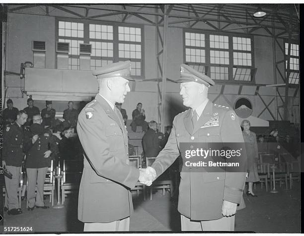 General Maxwell D. Taylor who led the Eighth Army through closing months of Korean War, is congratulated by General Thomas F. Hickey, Deputy...