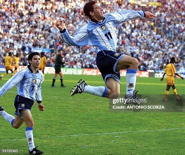 Javier Saviola of Argentina watches teammate Maximiliano Rodriguez celebrates his team's third goal against Ghana during their World Cup Sub-20...