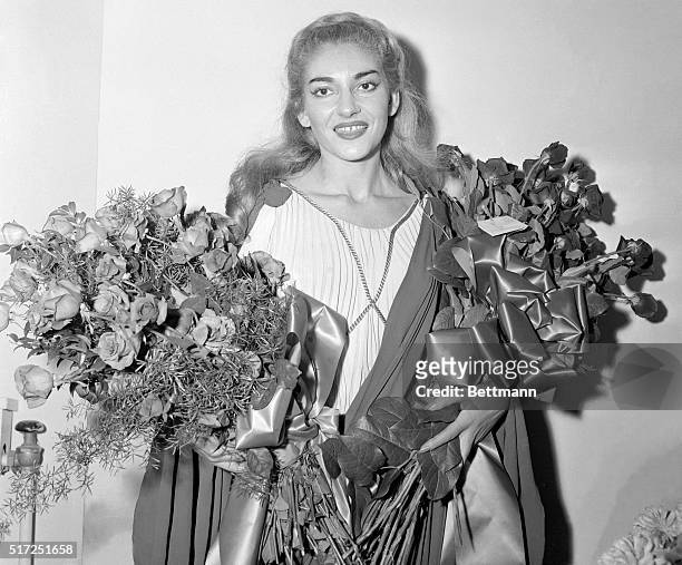 Flowers fill her arms as joy fills her heart--that is what this picture of soprano Maria Meneghini-Callas tells us. It was made after her impressive...