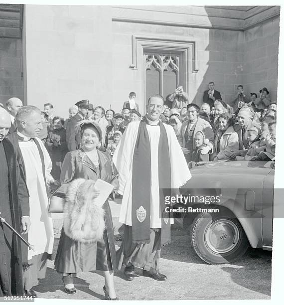 Interested spectators, including several children, look on, as Queen Mother Elizabeth leaves Washington Cathedral November 7th after attending Sunday...