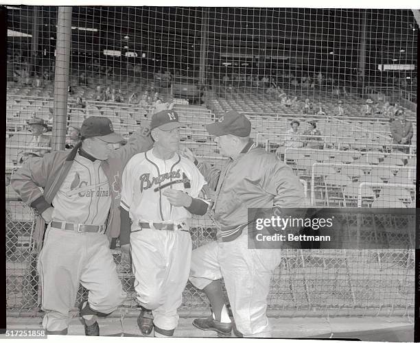 Cincinnati Reds manager Birdie Tebbetts talks with manager Charlie Grimm of the Braves and manager Eddie Stanky of the Cardinals before the protested...