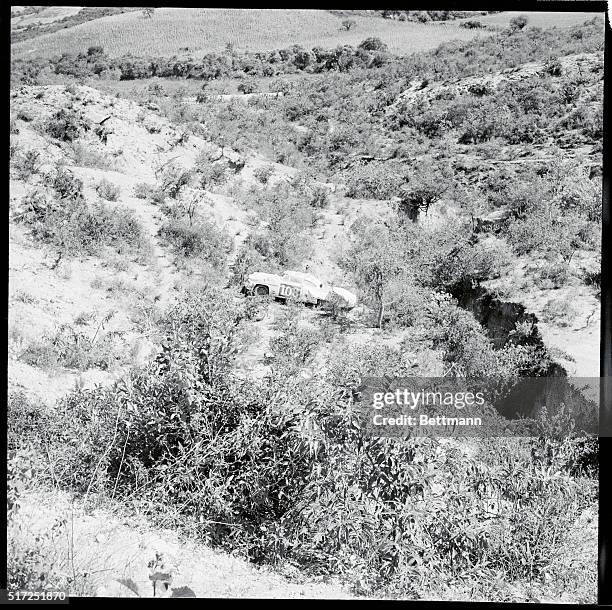 The Lincoln driven by Bill Vucovitch of Fresno, Calif., lies at the bottom of a valley near Oaxaca after plunging off the road and down a steep slope...