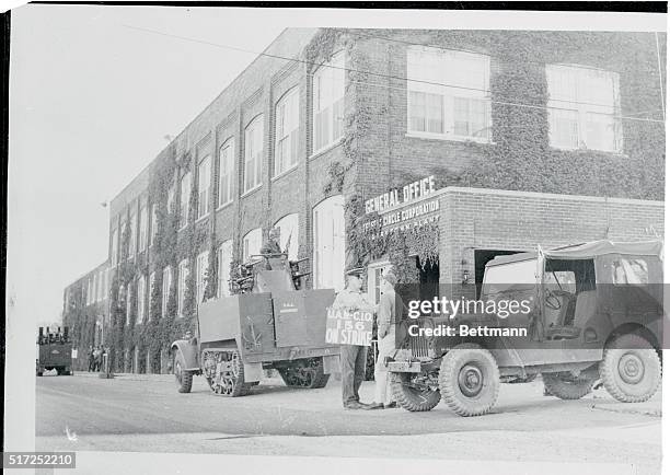 Hagerstown, Indiana: CIO United Auto Workers picketers chat in front of the headquarters building of the Perfect Circle Corporation while a national...