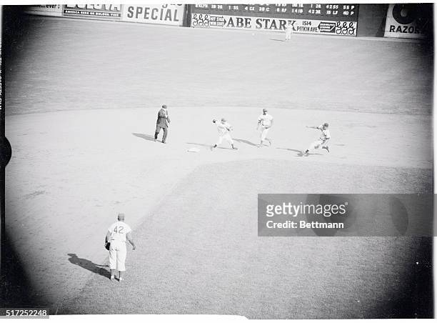 Calling While He's Out. New York: As Elston Howard slides, Umpire Jim Honochick calls him out on a force play at second and Peewee Reese throws to...