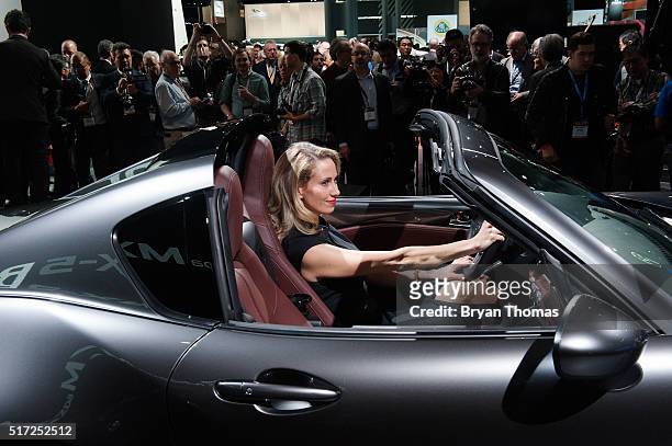 Model sits in the driver seat of the Mazda MX-5 RF following its introduction at the New York International Auto Show at the Javits Center on March...