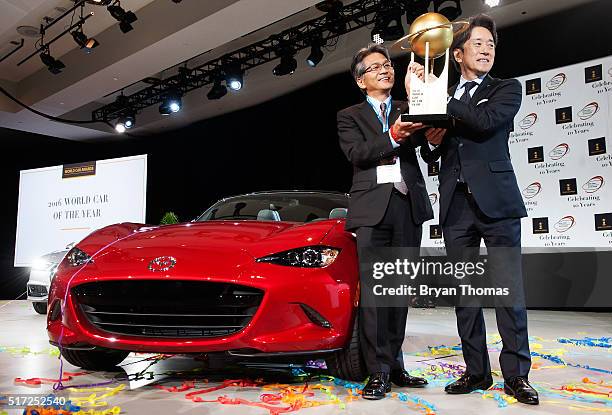 Mazda's Program Manager for the Mazda MX-5 Nobuhiro Yamamoto and President of Mazda North American Operations Masahiro Moro accept the 2016 World Car...