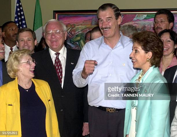 Mexican President Vicente Fox gestures to photographers as he and Illinois Gov. George Ryan and their wives Lura Lynn Ryan and Martha Sahagun de Fox...
