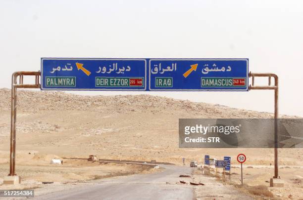 Sign is seen indicating a road leading to the ancient Syrian city of Palmyra on March 24, 2016. Backed by Russian warplanes and allied militia on the...