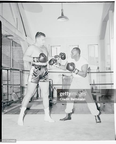 Ex-heavyweight champ Jersey Joe Walcott put on the gloves for the first time shince he was dethroned by Rocky Marciano, when he arrived at Columbia...