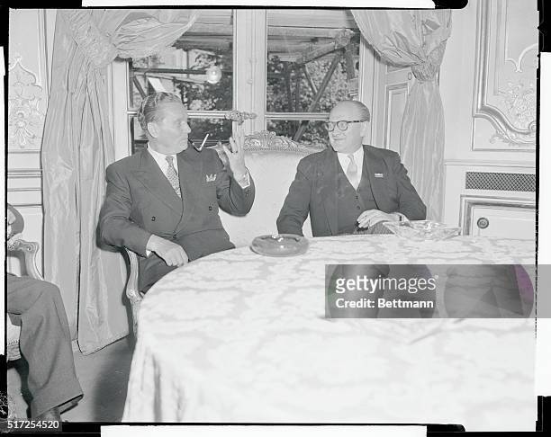 Paris: Tito And Mollet Converse. French Premier Guy Mollet, , converses with Marshal Tito of Yugoslavia, who is here on a state visit, in the...