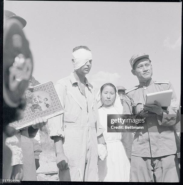 Reds Released Downed Pilot. Seoul, Korea: Lt. Guy H. Bumpas of Jackson, Miss., with head bandaged, is escorted into a demilitarized zone in Korea by...