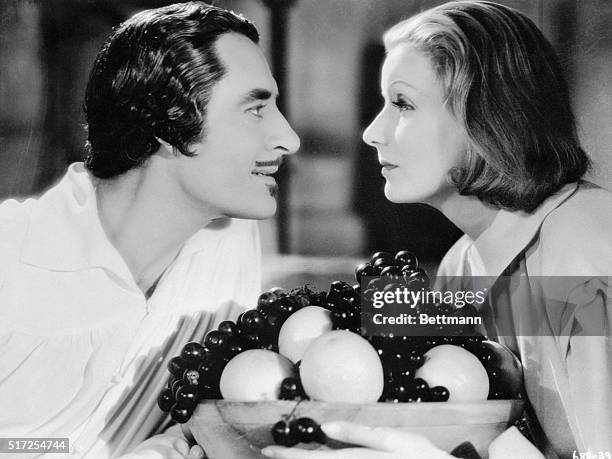 Garbo And Gilbert-Greta and H=John Gilbert blistering the screen in a love scene from Queen Christina which will be inclined on ABC-TV's, MGM Parade,...