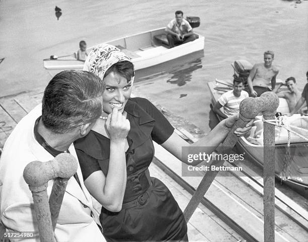 Movie stars Sophia Loren and Cary Grant, here to film a new motion picture, took advantage of Washington's ILD summer weather to feed the pigeons in...