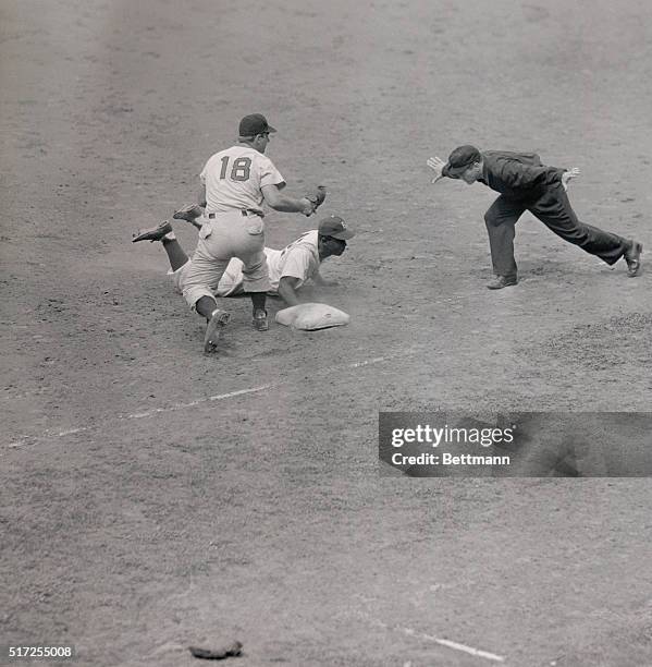 In an unsuccessful attempt to pick Dodger Jackie Robinson off at first base in the 6th inning of this Brooklyn-Cincinnati game, the Cincinnati...